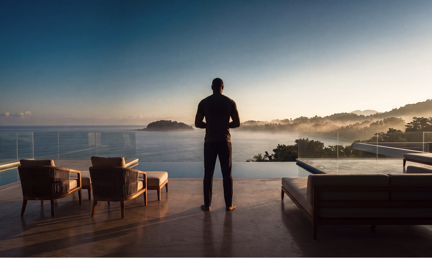 A person on a terrace watching the sunrise over the ocean