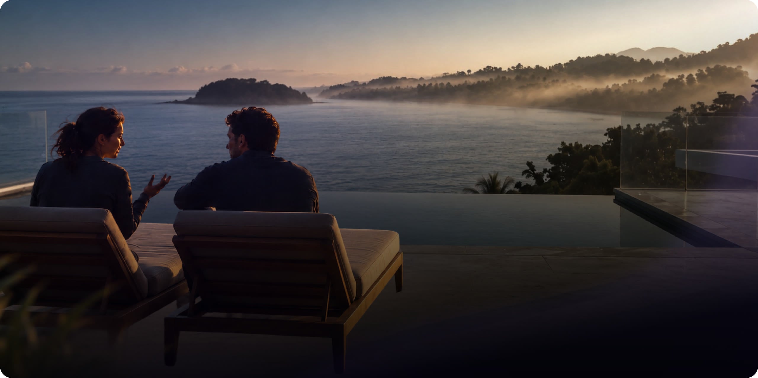 Two people talking on a terrace above the sea at sunrise